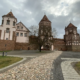 Mir Castle's red brick towers at the end of a cobbled path, Belarus