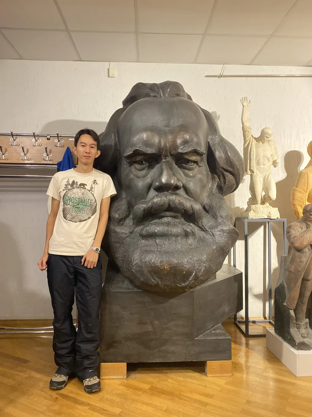 Spencer Li beside the giant bronze head of Karl Marx in the Azgur studio museum