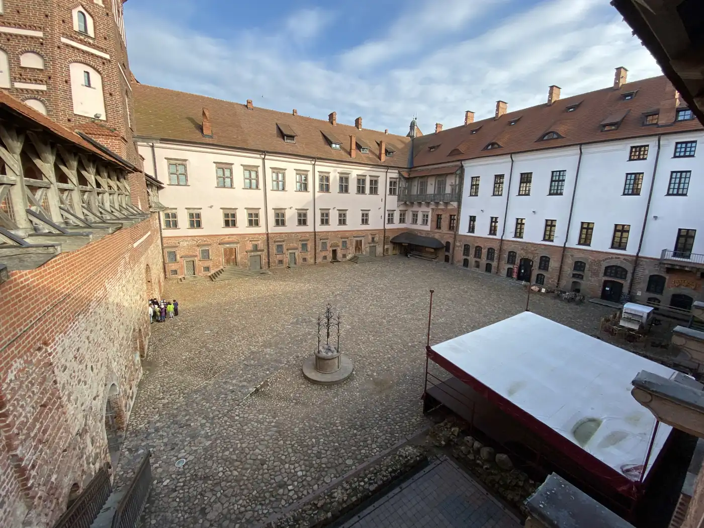The courtyard of Mir Castle inside its brick and white walls