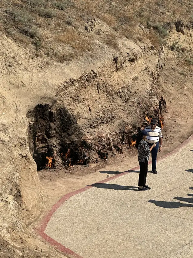 Flames along the base of the hillside at Yanar Dag near Baku