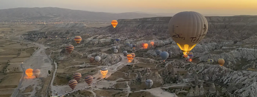 Hot air balloons over the Cappadocia valleys at sunrise