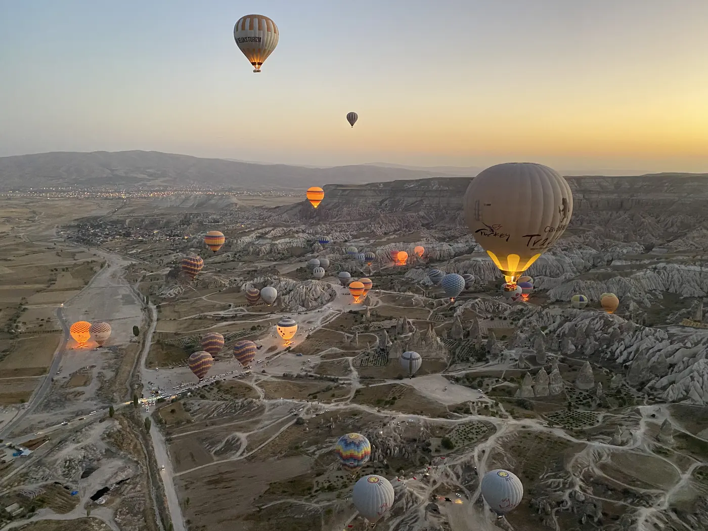 Hot air balloons over the Cappadocia valleys at sunrise