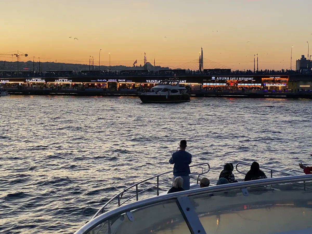 Sunset over the water from a Bosphorus cruise, Galata Bridge behind