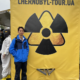 Spencer Li in front of a yellow radiation symbol banner at the Dytyatky checkpoint into the Chernobyl zone