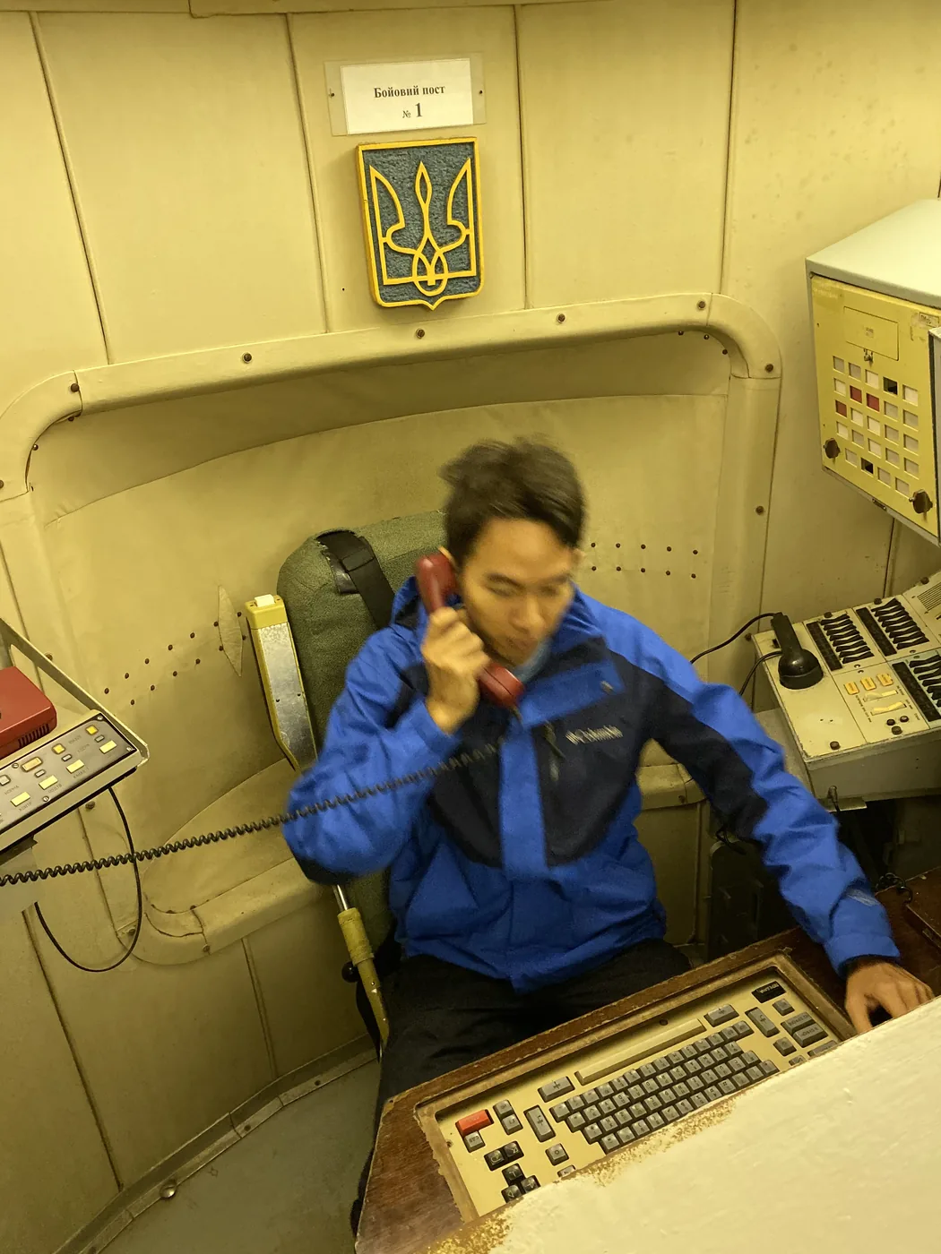 Spencer Li in the duty seat of the launch room with the red phone