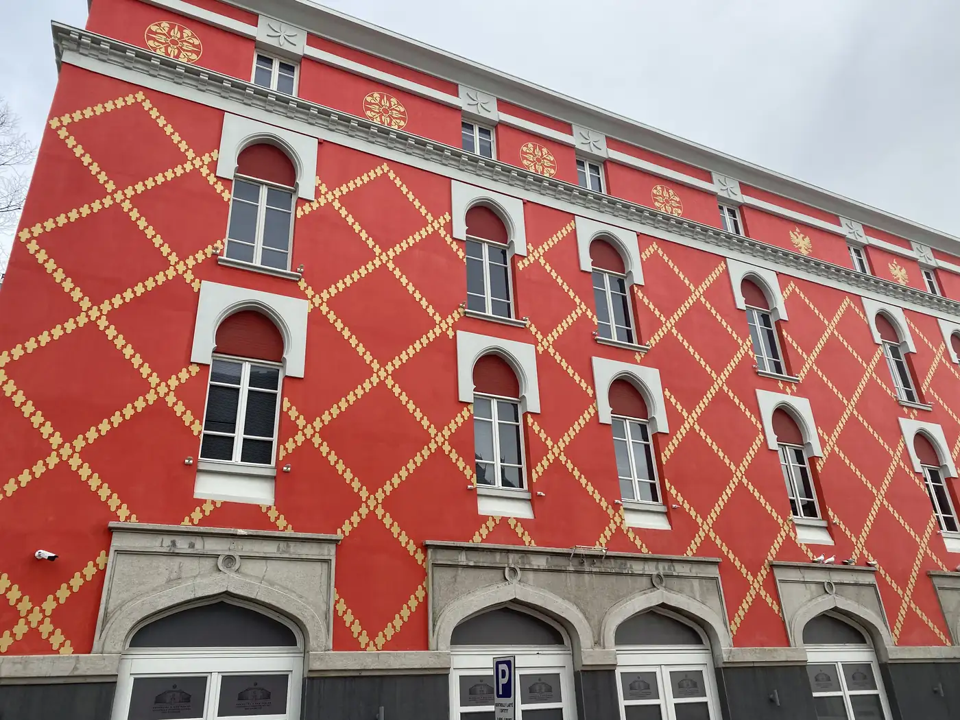 A red and gold patterned facade, Tirana
