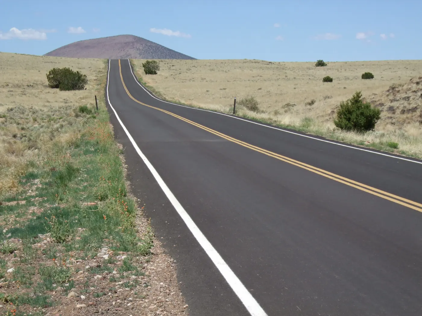 An empty road to a cinder cone