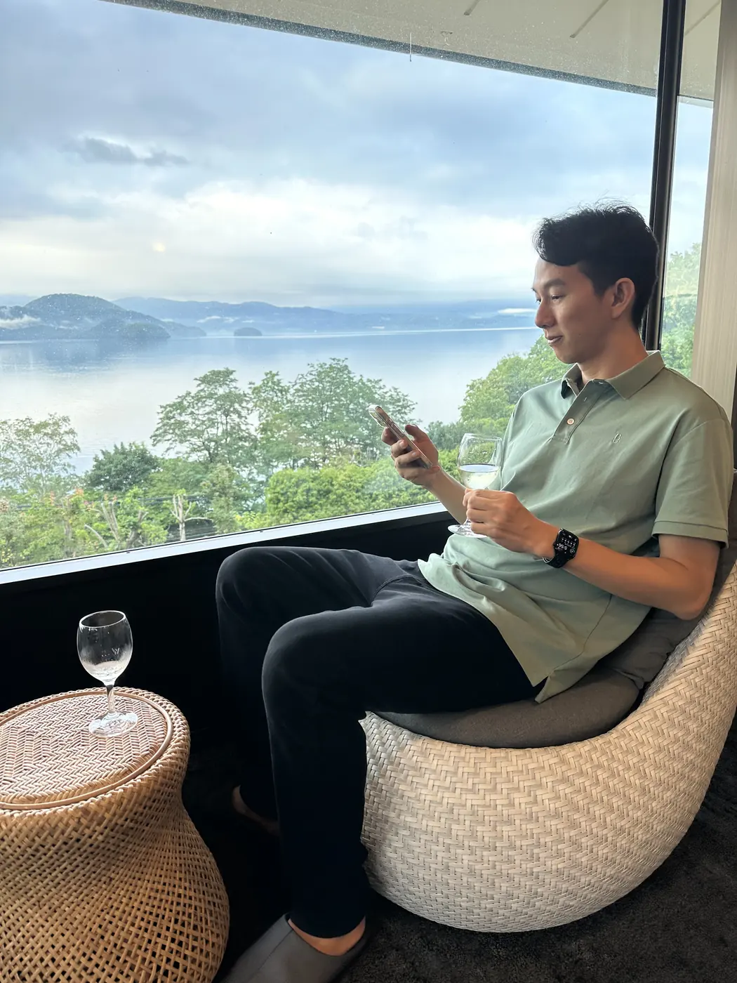 Checking the markets on a phone in the Lake Toya hotel lounge