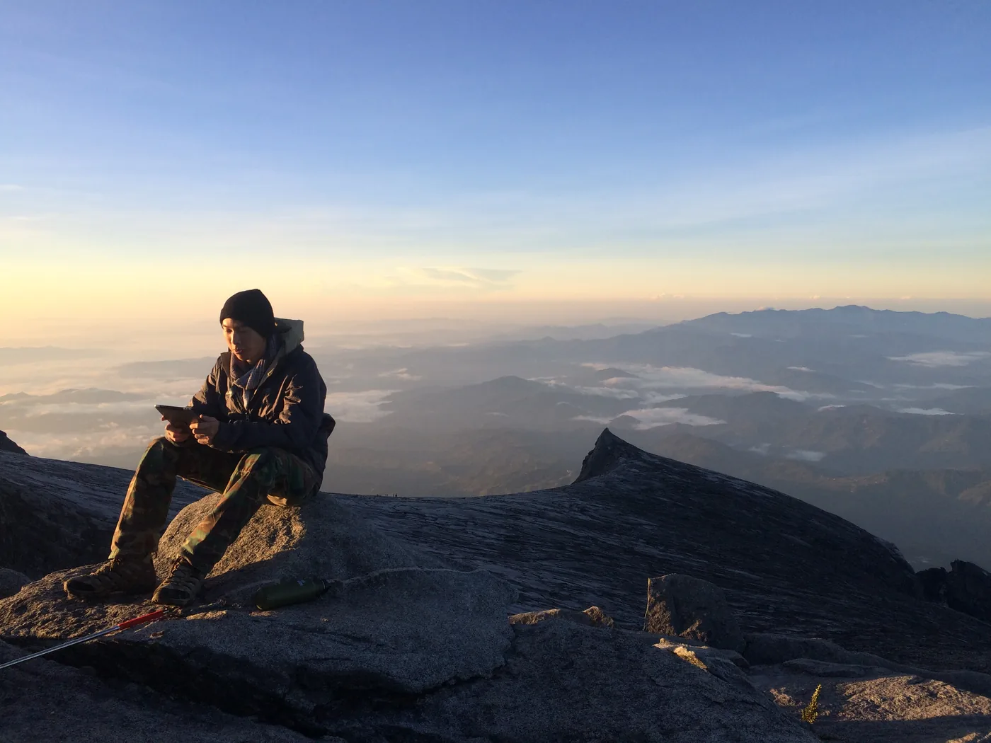Checking the markets on the summit of Mount Kinabalu, a sea of cloud behind