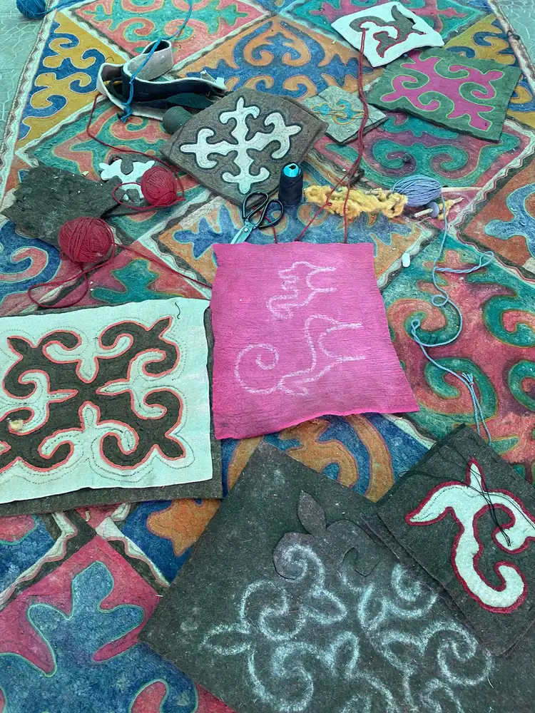Coloured felt squares with Kyrgyz horn patterns at a felt workshop in Kochkor