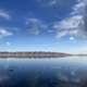 Song-Kol Lake reflecting the sky and mountains at dusk, Kyrgyzstan