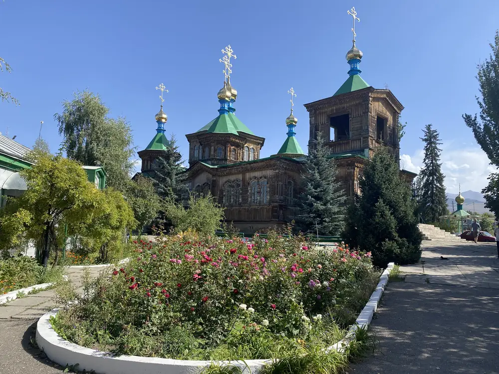 The wooden Holy Trinity Cathedral in Karakol with green domes