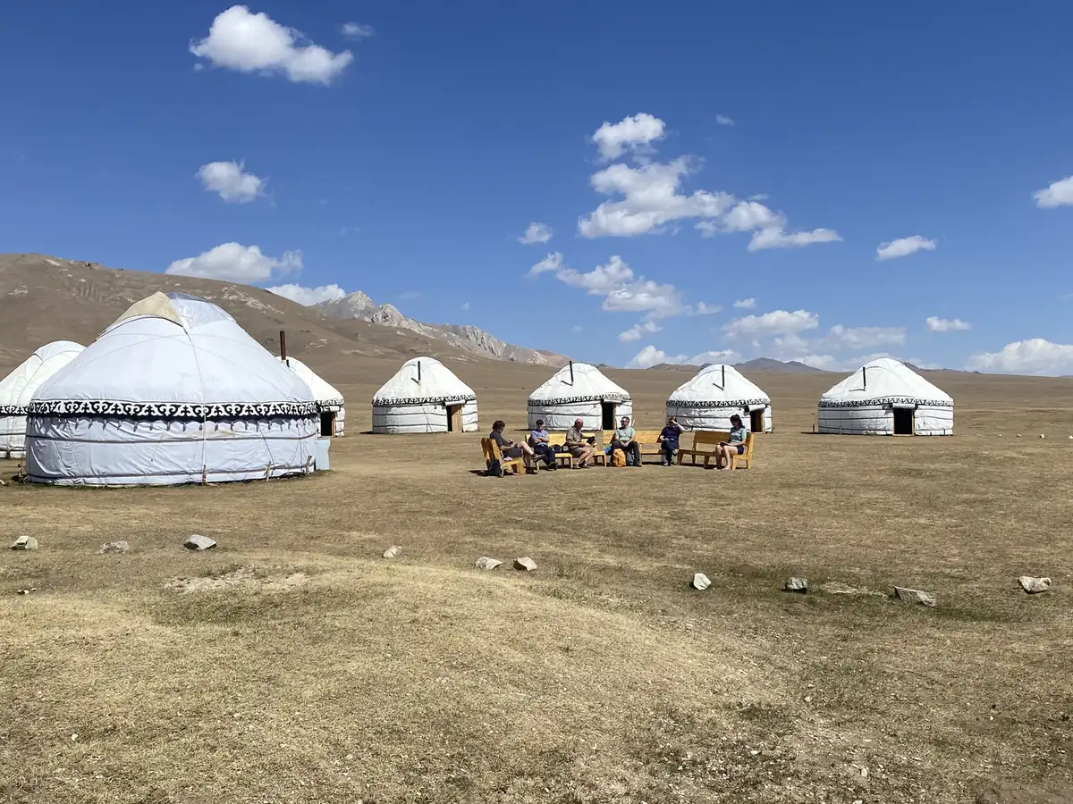 White yurts of a camp on the pasture above Song-Kol Lake