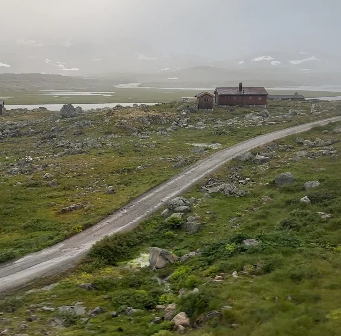 The mountain plateau and a red hut, from the Bergen train