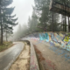 A graffiti-covered bend of the 1984 Olympic bobsleigh track on Mount Trebevic in fog