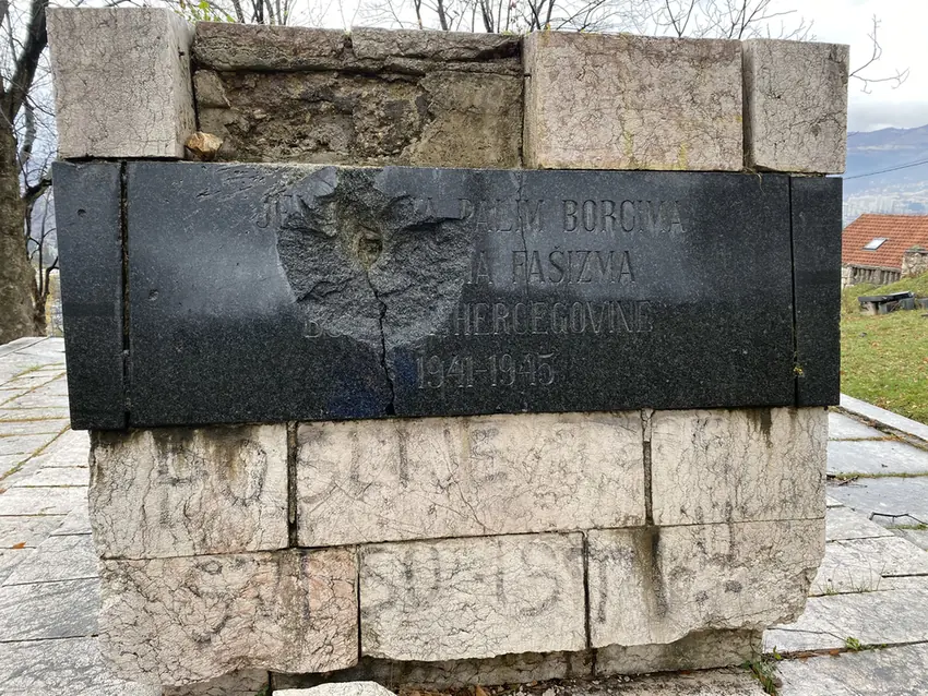 A shell-damaged granite memorial plaque for 1941 to 1945 in the Old Jewish Cemetery, Sarajevo