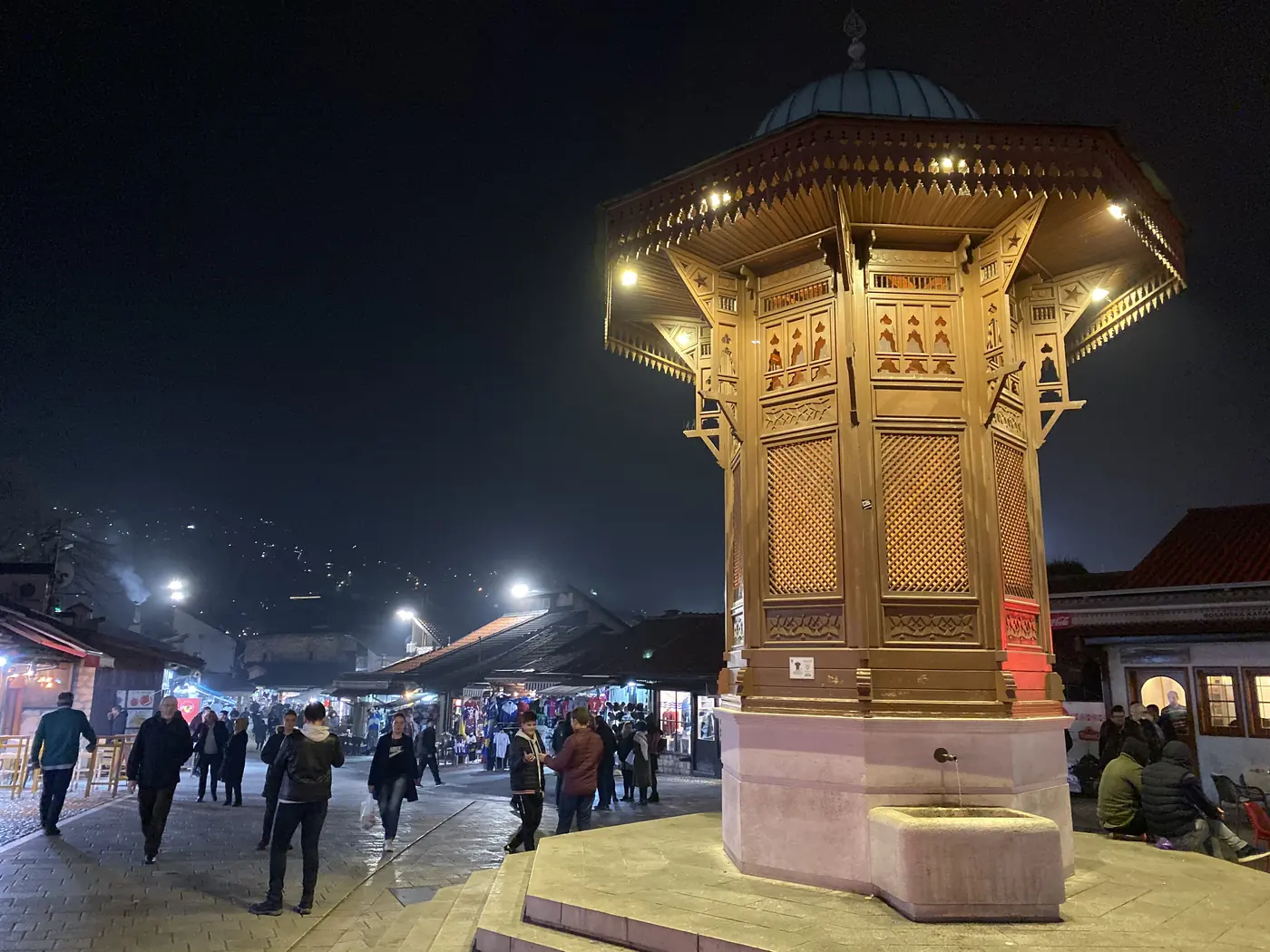 The wooden Sebilj fountain lit up at night in Bascarsija, Sarajevo