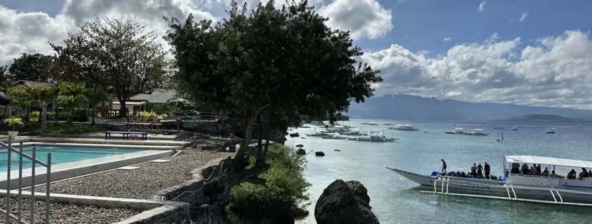 The coast at Moalboal, Cebu, with island boats offshore