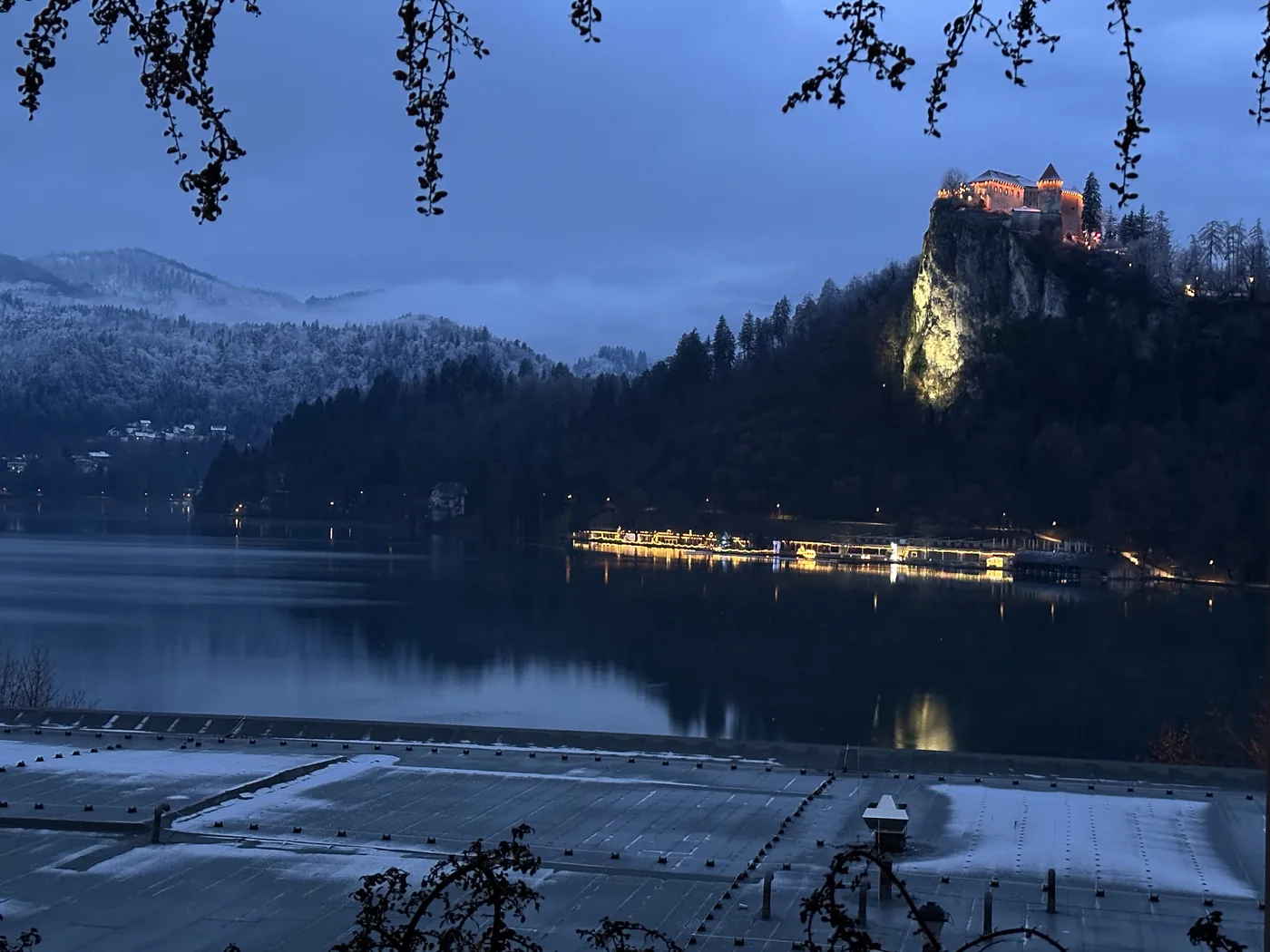 Bled Castle lit on its cliff at dawn