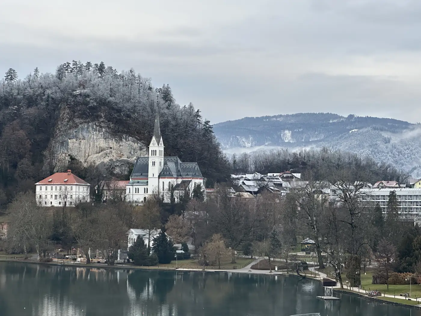 Bled's church and cliff, snow on the hills, Christmas morning