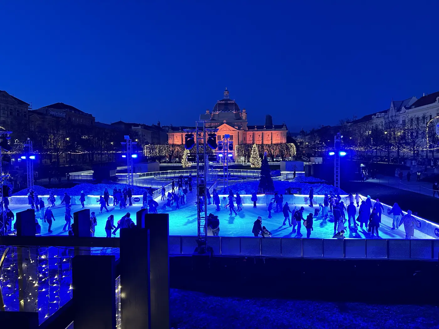 The blue-lit Advent ice rink at night