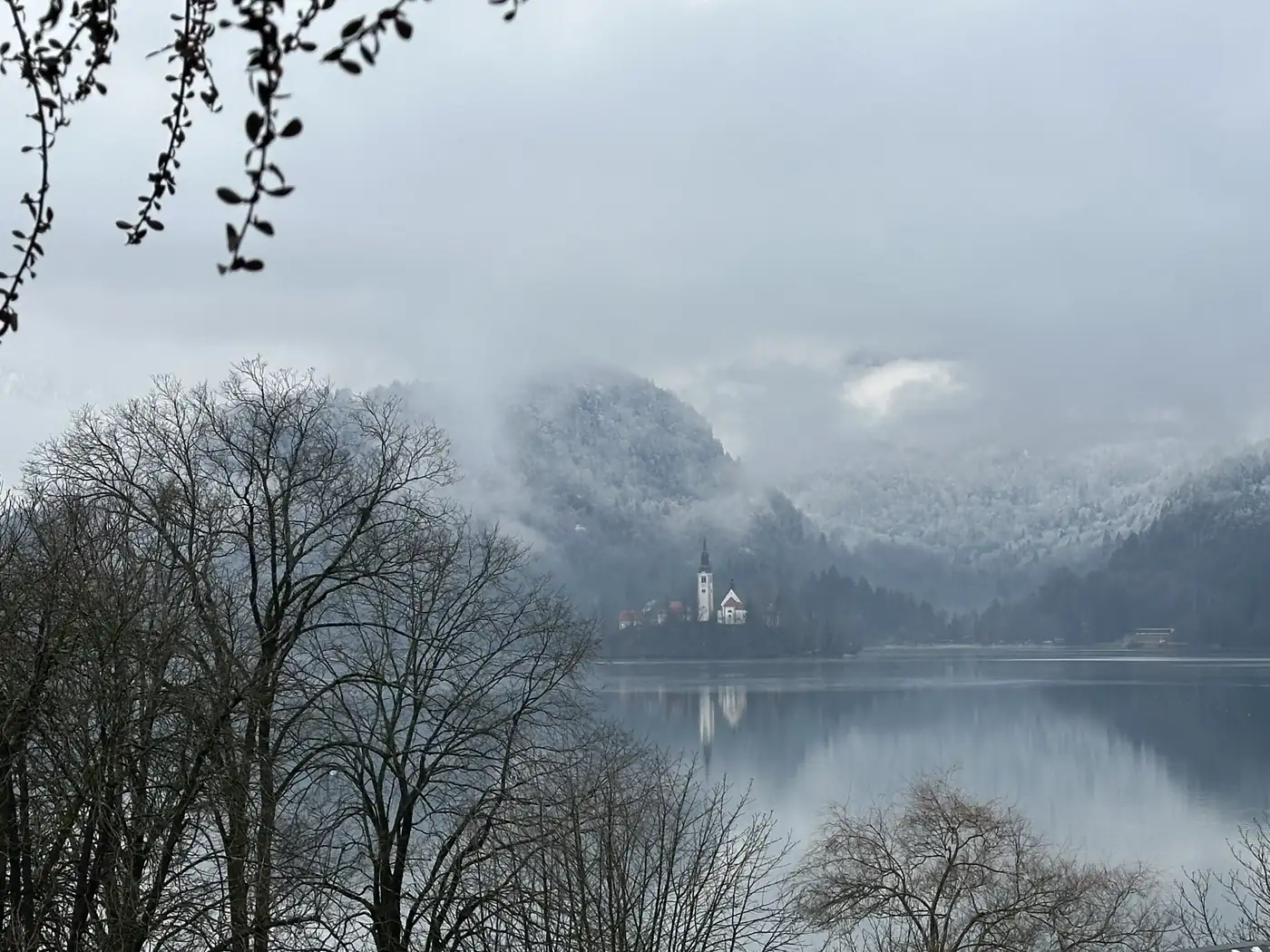 The island church in mist, the Alps behind