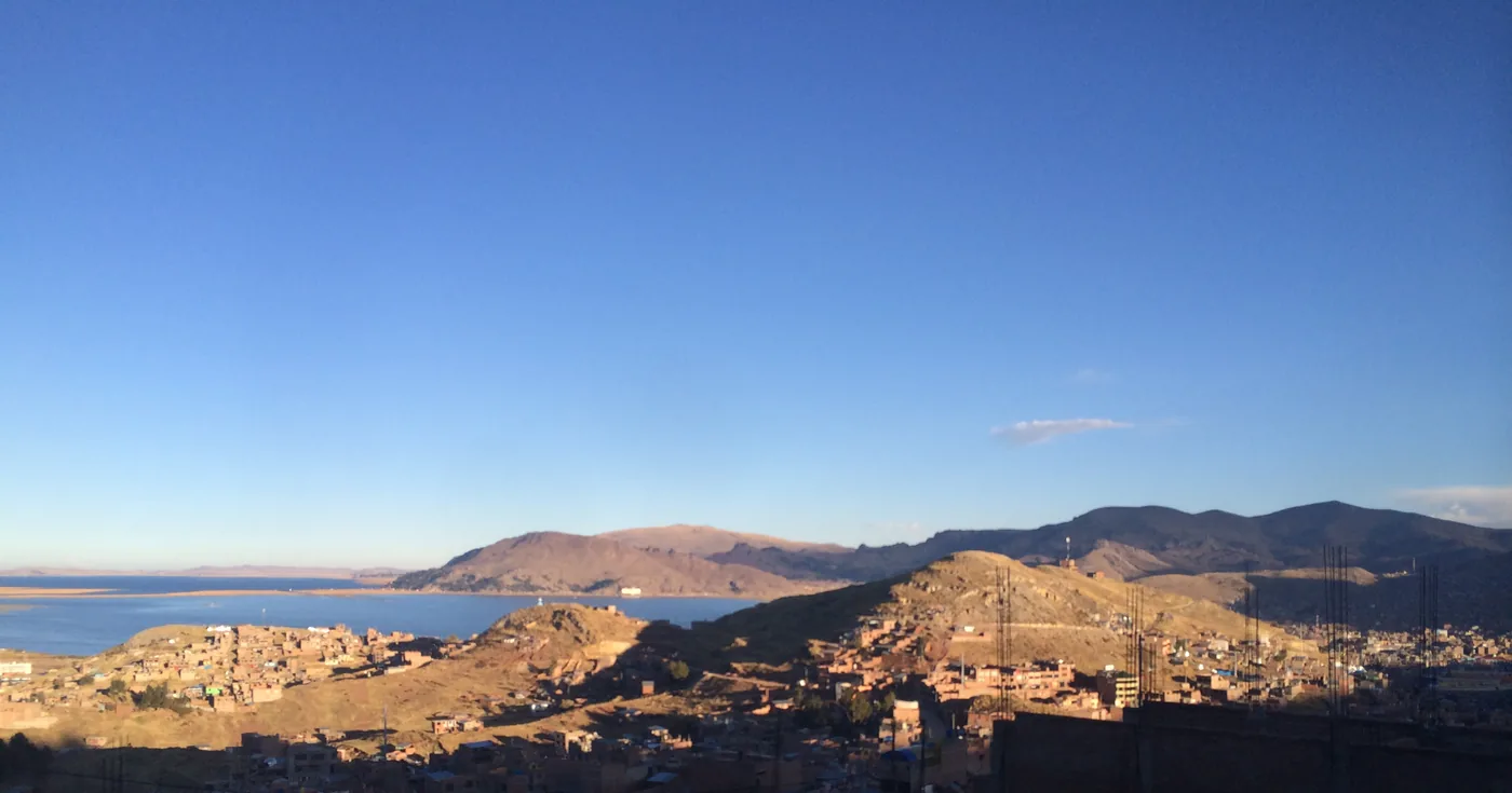 Puno on the hillside, Lake Titicaca behind