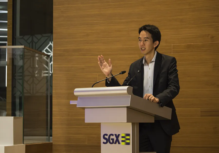 Spencer Li speaking at a Singapore Exchange podium