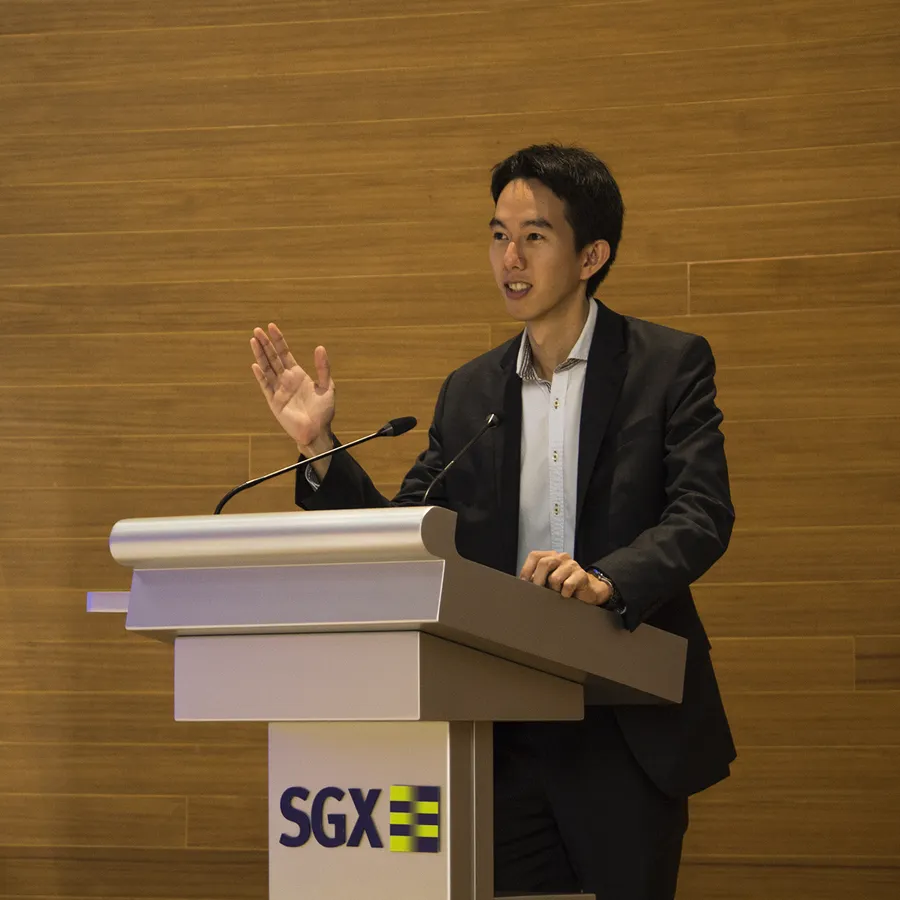 Spencer Li speaking at a Singapore Exchange podium