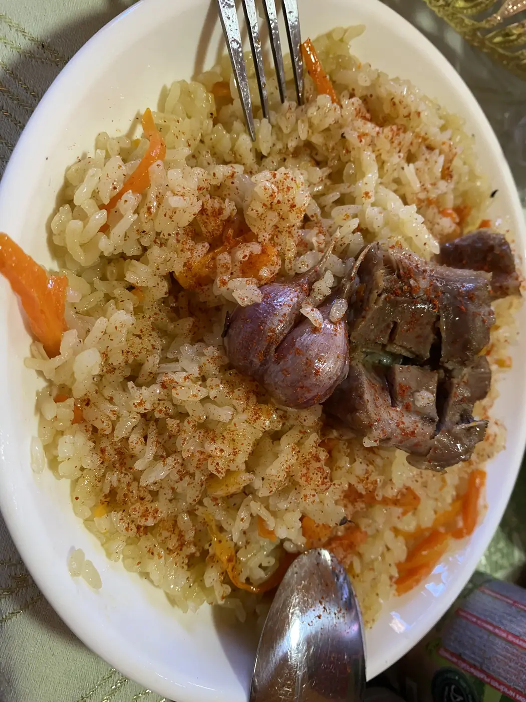 A plate of plov, rice with carrots and meat