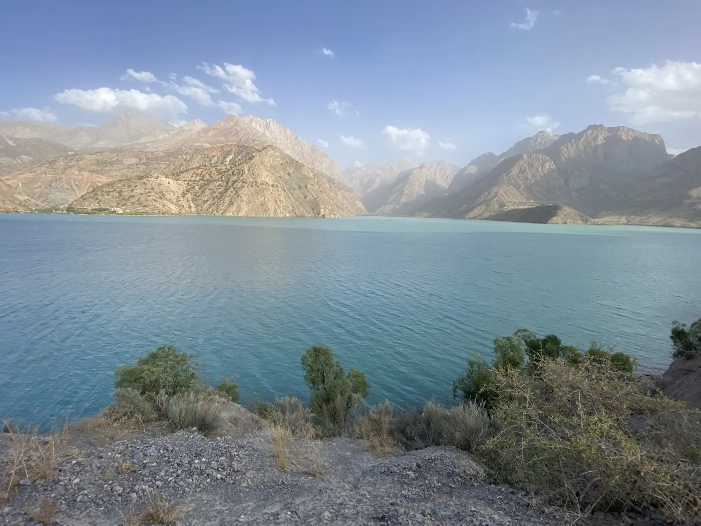 Turquoise Iskanderkul lake ringed by bare mountains