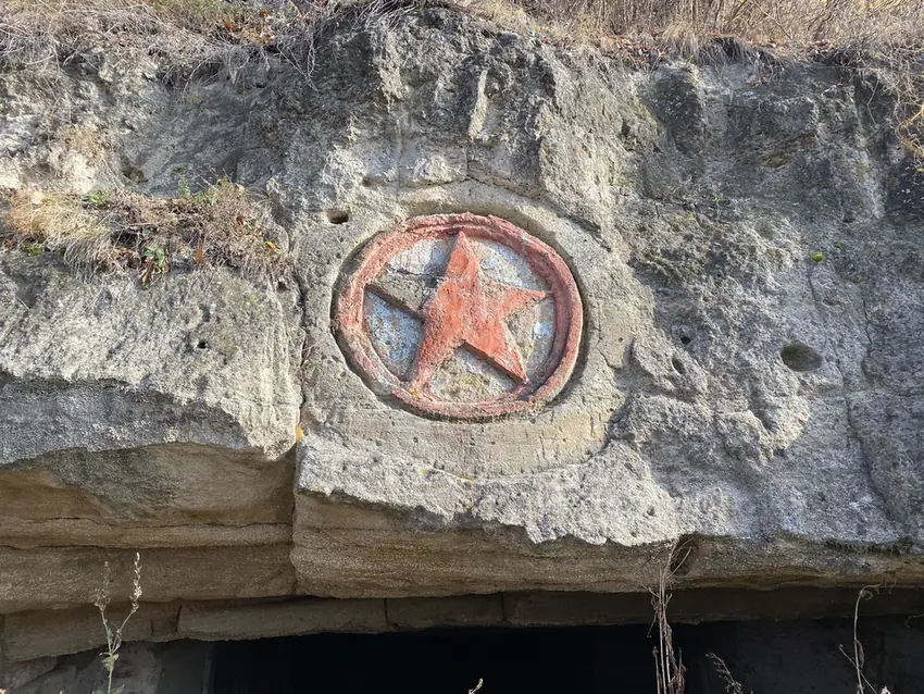 Red star carved into a limestone quarry cliff in Transnistria