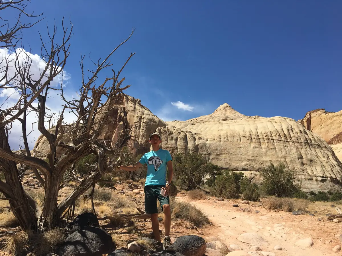 Spencer on a trail below the white sandstone domes of Capitol Reef