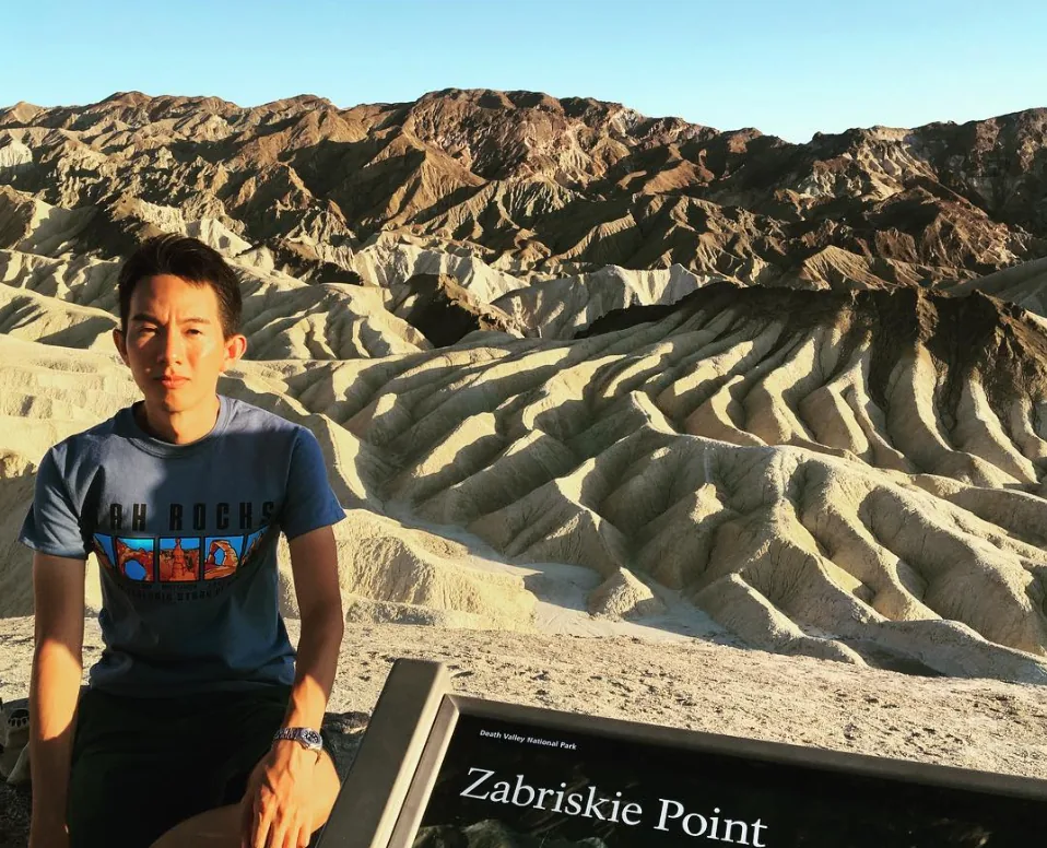 Spencer at Zabriskie Point in Death Valley, with the badlands behind